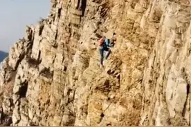 女子徒手攀爬大黑山峭壁，一旦失足后果严重图片