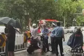 交警查电动车，男子高举双手大喊一声“枪毙我吧”，群众纷纷拍照图片